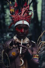 PAPUA NEW GUINEA, People, "Portrait of woman wearing traditional dress and jewellery, elaborate red