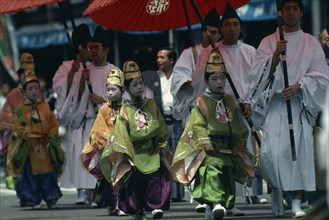 JAPAN, Honshu, Kyoto, Gion Festival.  Pageboys in elaborate costume parade in festival procession