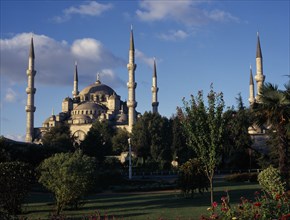 TURKEY, Istanbul, Blue Mosque. Sultan Ahmet Camii. View from gardens in golden light with blue sky