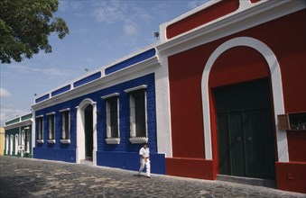 VENEZUELA,  Bolivar State, Ciudad, "Red, blue and white painted house frontages near Plaza Bolivar