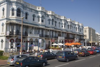 ENGLAND, West Sussex, Worthing, Bars and restaurants lining Marine Parade by seafront