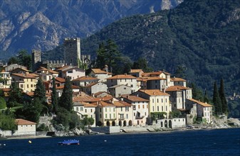 ITALY, Lombardy, Lake Como, Rezzonico.  View across lake to red tiled rooftops of village houses