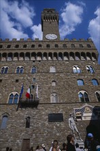 ITALY, Tuscany, Florence, Piazza della Signoria. Palazzo Vecchio entrance and bell tower with a