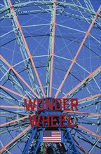 USA, New York, New York City, Coney Island.  Ferris wheel painted blue and orange with sign in red