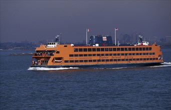 USA, New York, New York City, Staten Island ferry with city skyline beyond.