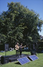 ENGLAND, East Sussex, Lewes, Guitar festival performers with solar powered amplifier systems.