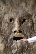 ITALY, Lazio, Rome, The 2nd Century BC drain cover Bocca della Verite or Mouth of Truth mounted ona