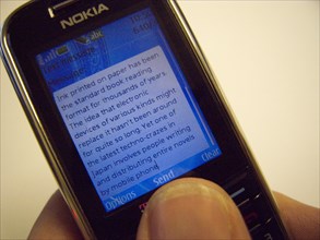 COMMUNICATIONS, Telephone, Mobile, "Nokia mobile phone showing text message with article about