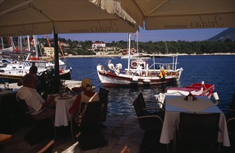GREECE, Ionian Islands, Cephalonia, Waterside cafe in Fiskardo harbour.