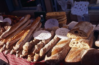 FRANCE, Midi Pyrenees, Pryassac, Bread for sale on market stall.