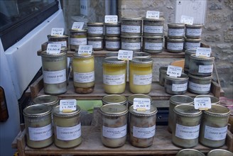 FRANCE, Midi Pyrenees, Pryassac, Jars of Pate and Foie Gras on sale in the market.