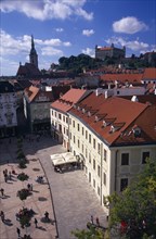 SLOVAKIA, Bratislava, "View over paved square and cafe, across red tiled rooftops of the Old Town