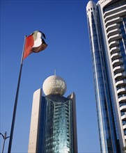 UAE, Dubai, Deira, Etisalat Building on Dubai Creek with flag pole in foreground.