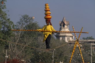 INDIA, Rajasthan, Jaipur, Young boy balancing on the high wire at the Jaipur Heritage Festival