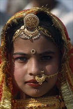 INDIA, Rajasthan, Jaisalmer, Head and shoulders portrait of a young girl wearing traditional