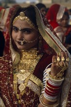 INDIA, Rajasthan, Jaisalmer, Portrait of a Miss Desert contestant wearing traditional jewellery at