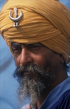 INDIA, Punjab, Kila Raipur, Portrait of Nihang a member of the Sikh Warrior caste wearing his