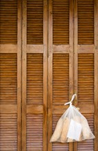 MALTA, Saint Julians, Plastic bag containing loaves of fresh bread tied to the handle of wooden