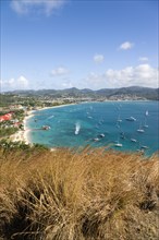 WEST INDIES, St Lucia, Gros Islet , Beach lined Rodney Bay with yachts at anchor seen from Signal