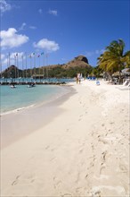 WEST INDIES, St Lucia, Gros Islet , Tourists on the beach at Sandals Grande St Lucian Spa and Beach