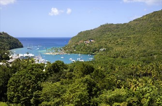 WEST INDIES, St Lucia, Castries, Marigot Bay with boats at anchor in the harbour below lush