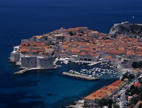 CROATIA, Dalmatia, Dubrovnik, Elevated view over the Old City Harbour with fortified walls. Yachts