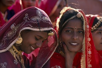 INDIA, Rajasthan, Bikaner, Young girl dancers smiling at the Camel Festival