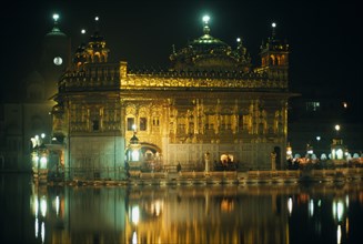 INDIA, Punjab, Amritsar, The Golden Temple illuminated at night