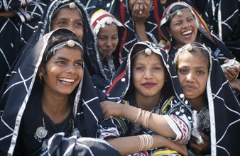 INDIA, Rajasthan, Alwar, Group of young dancers smiling and laughing at the Alwar Utsav Festival