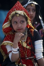 INDIA, Rajasthan, Alwar, Young girl dancer wearing traditional jewellery at the Alwar Utsav
