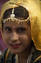 INDIA, Rajasthan, Alwar, Head and shoulders portrait of a young girl at the Alwar Utsav Festival