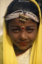 INDIA, Rajasthan, Alwar, Head and shoulders portrait of a young girl dancer at the Alwar Utsav