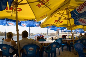 MALTA, Valletta, Passengers waiting for the ferry to Sliema under sunshade umbrellas on the