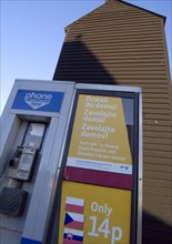 ENGLAND, East Sussex, Hastings, A public telephone kiosk advertising cheap calls to Eastern