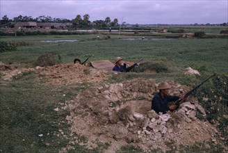 VIETNAM, War, "North Vietnamese combat troops, positioned with rifles and machine gun in dug-outs