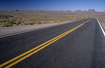 USA, Arizona , Monument Valley, "View from US Highway 163 across empty stretch of road leading to