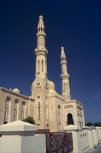 UAE, Dubai, Jumeirah Mosque.  Angled view of exterior with pair of minarets and domed rooftop