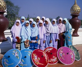 THAILAND, North, Chiang Mai, "Group of young Muslim Thai women standing behind blue, red, pink and