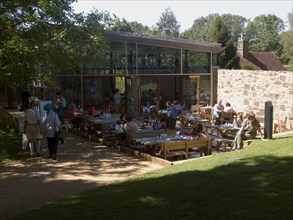 ENGLAND, East Sussex, Battle, Battle Abbey. Modern cafe in abbey grounds with visitors at outside