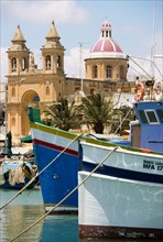 MALTA, Marsaxlokk , Fishing village harbour on the south coast with colourful fishing boats and the