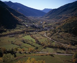 SPAIN, Aragon, Huesca, Village of Broto on valley floor and surrounding landscape in Autumn colours