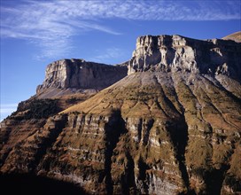 SPAIN, Aragon, Valle de Ordesa, Eroded cliffs above Bosque de Las Hayas.  Grey rock scattered with