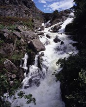 WALES, Gwynedd, Snowdonia National Park, Ogwen Falls and Nant Ffrancon Pass.   White foaming water