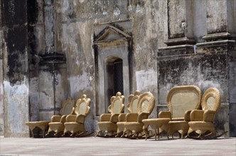 NICARAGUA, Leon, "Street scene with line of wicker chairs and tables outside building with