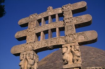 INDIA, Madhya Pradesh, Sanchi, Part view of the Great Stupa and carved gateway or torana.