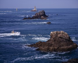 FRANCE, Brittany, Finistere, "Pointe du Raz.  Jagged outcrops of offshore rock protruding from sea