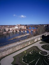 FRANCE, Midi-Pyrenees, Tarn, Albi.  View across town over gravel paths and clipped hedges of