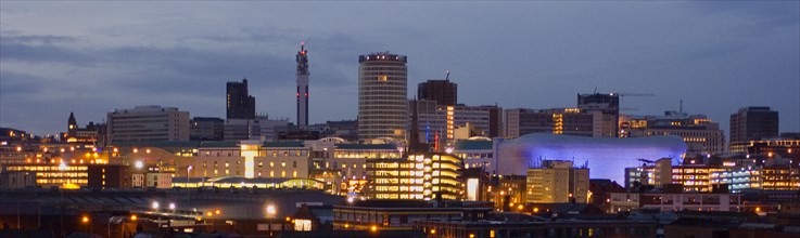 ENGLAND, West Midlands, Birmingham, City skyline illuminated in evening light