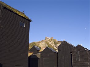 ENGLAND, East Sussex, Hastings, Black wooden huts used for storing fishing nets.The East Hill Lift