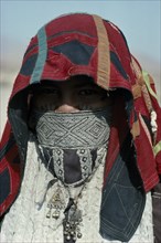 SUDAN, East, People, Head and shoulders portrait of Rasheida nomadic woman wearing embroidered and